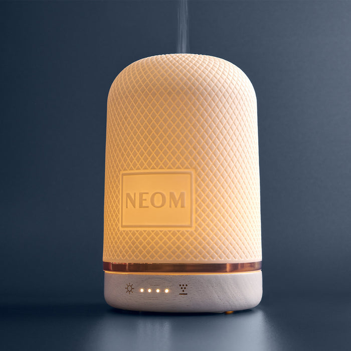 NEOM electric pod diffuser on a dark background