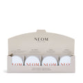 A set of four mini candles from NEOM, with labels indicating different scents such as 'Perfect Night’s Sleep', 'Real Luxury', 'Happiness', and 'Feel Refreshed'. The candles are presented in a sleek, minimalistic box with the NEOM branding.